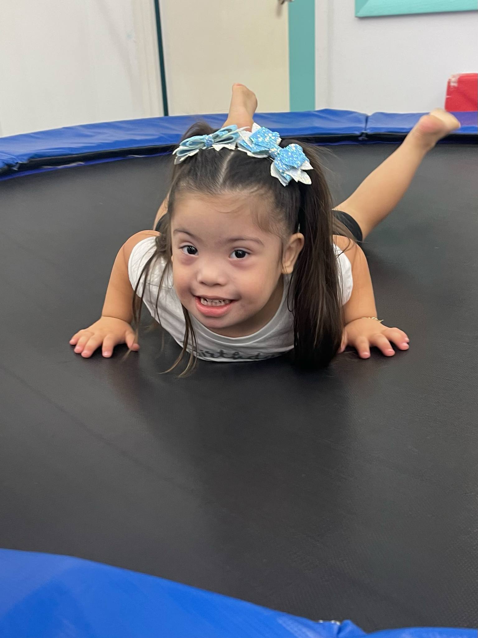 A child jumping on a trampoline at a Pom-Pom's Players event